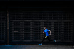 Athletic man running at urban street